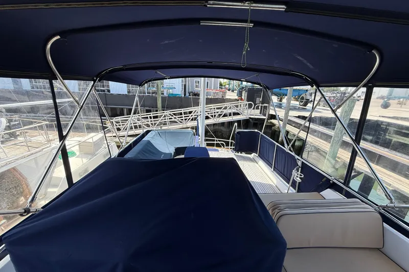 Slide: The Image of 2002 Grand Banks 42 Classic yacht interior with blue canopy and seating area. - 47