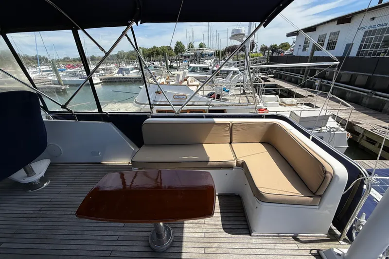 Slide: The Image of Grand Banks 42 Classic 2002 yacht deck with seating and table at marina. - 49