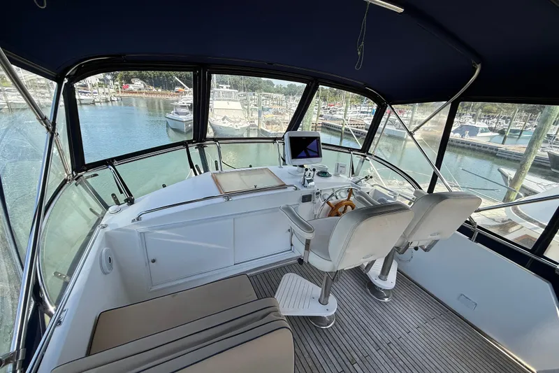 Slide: The Image of Helm of 2002 Grand Banks 42 Classic yacht with marina view. - 52