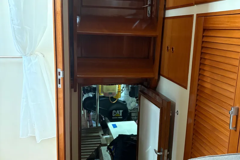 Slide: The Image of Engine room access on 2002 Grand Banks 42 Classic yacht, featuring wooden cabinetry. - 68