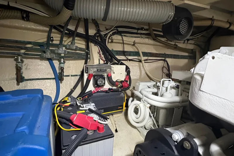 Slide: The Image of Engine room of 2002 Grand Banks 42 Classic, featuring battery and mechanical components. - 73