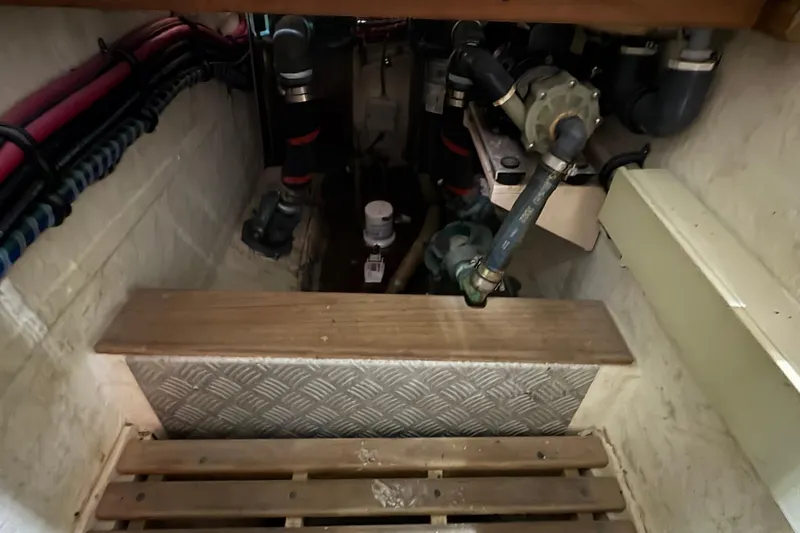 Slide: The Image of Engine room of 2002 Grand Banks 42 Classic yacht, showing pipes and mechanical components. - 75