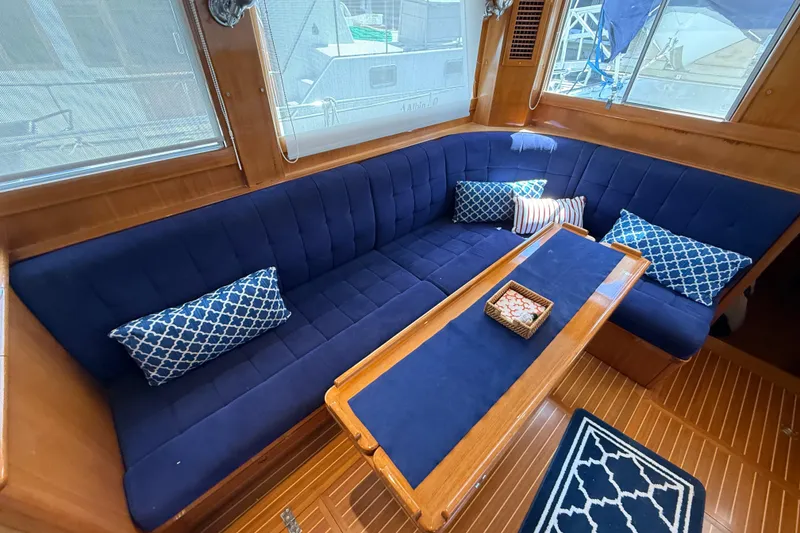 Slide: The Image of Luxurious interior of 2002 Grand Banks 42 Classic yacht with blue seating and decorative pillows. - 8
