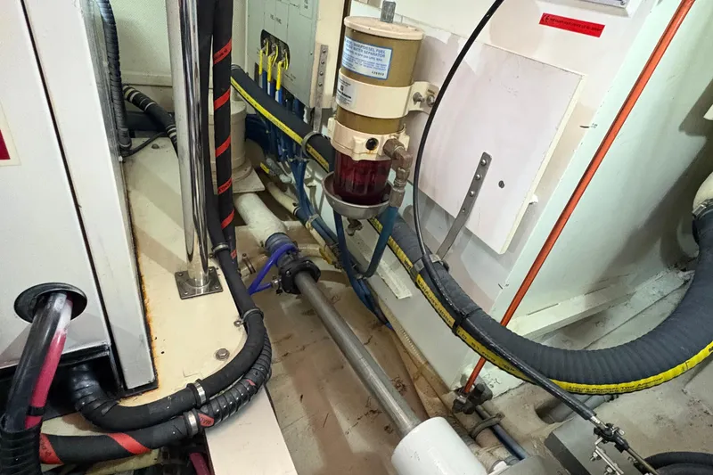 Slide: The Image of Engine room of 2002 Grand Banks 42 Classic yacht, showcasing mechanical components and wiring. - 81