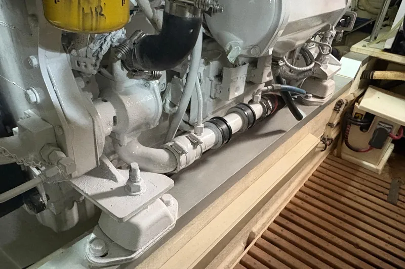 Slide: The Image of Engine compartment of a 2002 Grand Banks 42 Classic yacht, showcasing mechanical components. - 85