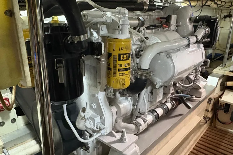 Slide: The Image of Engine room of a 2002 Grand Banks 42 Classic yacht, featuring a CAT fuel filter. - 86