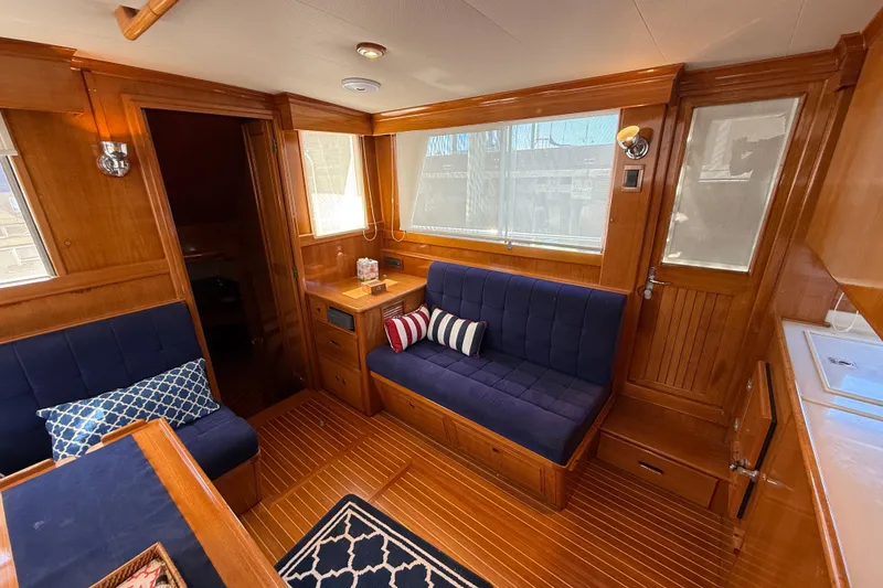 Slide: The Image of Luxurious interior of 2002 Grand Banks 42 Classic yacht with wooden finish and navy seating. - 9