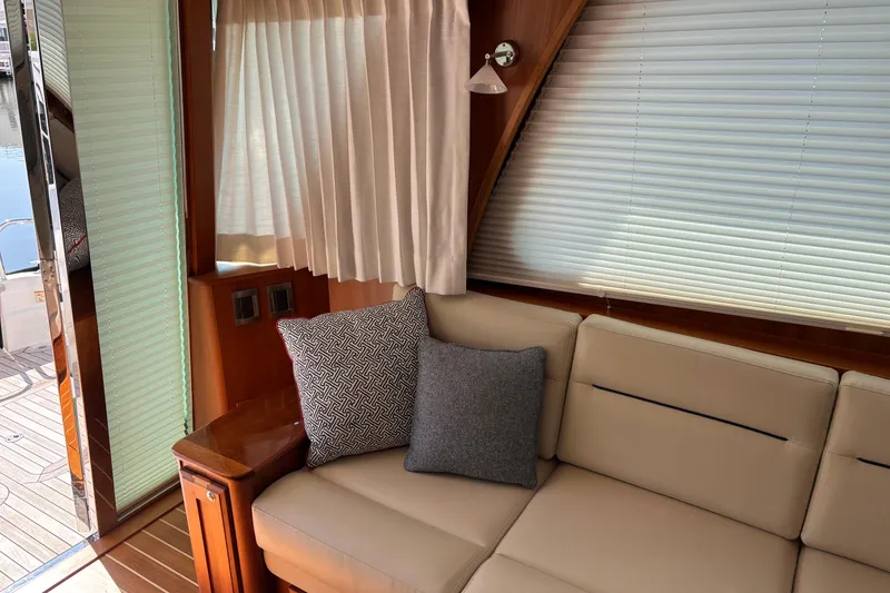 Slide: The Image of Interior of 2021 Sabre 48 Salon Express yacht with beige sofa and decorative pillows. - 10