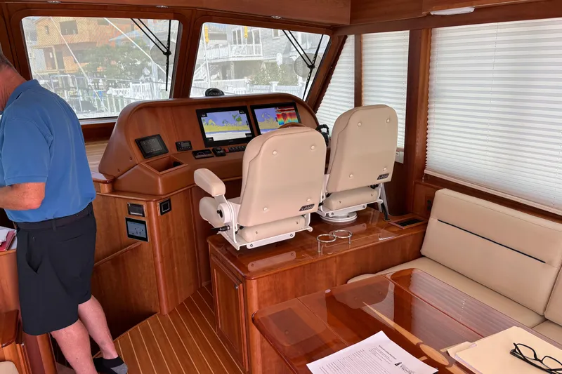 Slide: The Image of Interior of 2021 Sabre 48 Salon Express yacht with helm and seating area. - 12