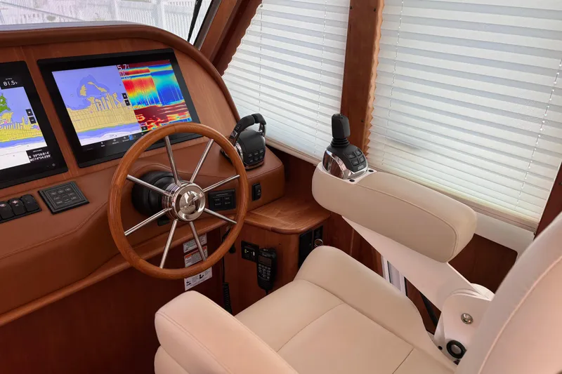Slide: The Image of 2021 Sabre 48 Salon Express helm with navigation screens and leather captain's chair. - 14
