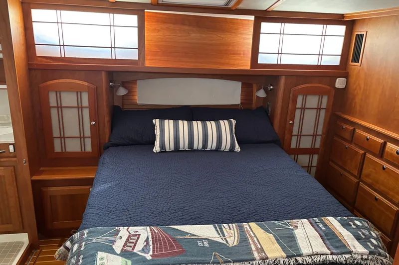 Slide: The Image of Luxurious cabin interior of 2021 Sabre 48 Salon Express with cozy bed and wooden furnishings. - 18