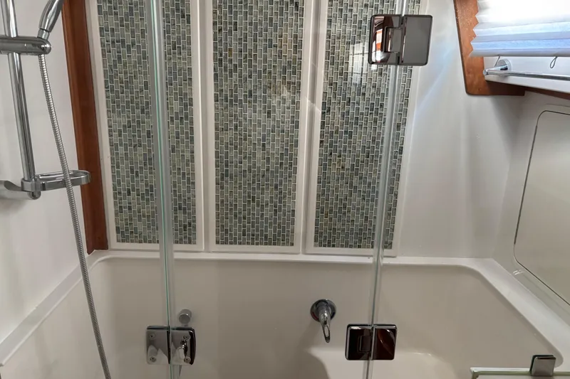 Slide: The Image of Modern bathroom in 2021 Sabre 48 Salon Express yacht with glass shower doors. - 20
