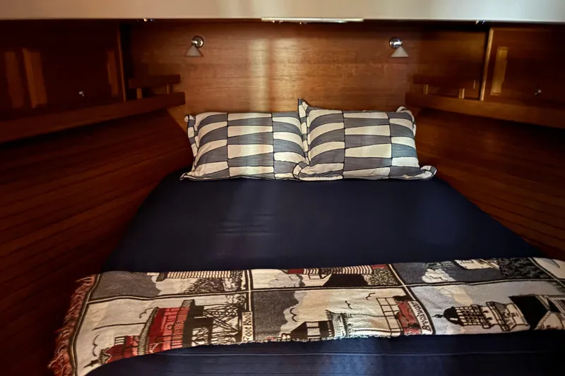 Slide: The Image of Cozy bedroom in 2021 Sabre 48 Salon Express yacht with striped pillows and nautical decor. - 22