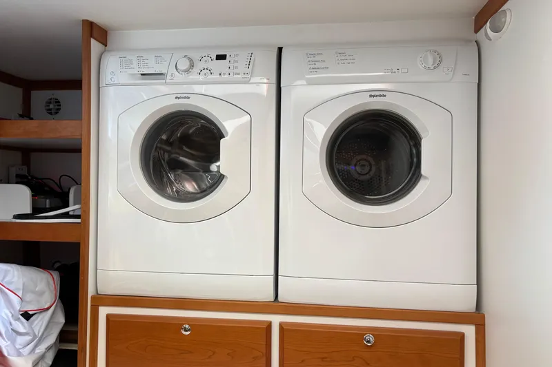 Slide: The Image of Laundry appliances inside a 2021 Sabre 48 Salon Express yacht. - 28