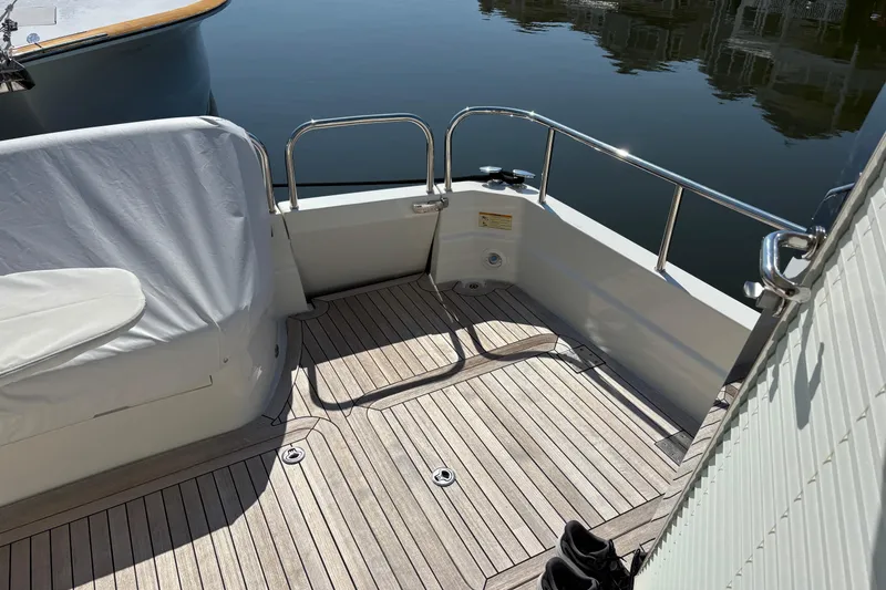 Slide: The Image of 2021 Sabre 48 Salon Express yacht deck with wooden flooring and railing. - 3
