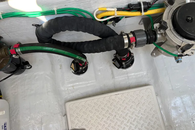 Slide: The Image of Engine compartment of 2021 Sabre 48 Salon Express with hoses and mechanical components. - 30