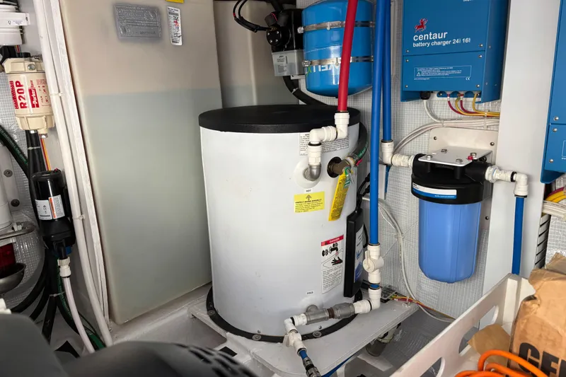 Slide: The Image of Engine room of 2021 Sabre 48 Salon Express with water heater and battery charger. - 32