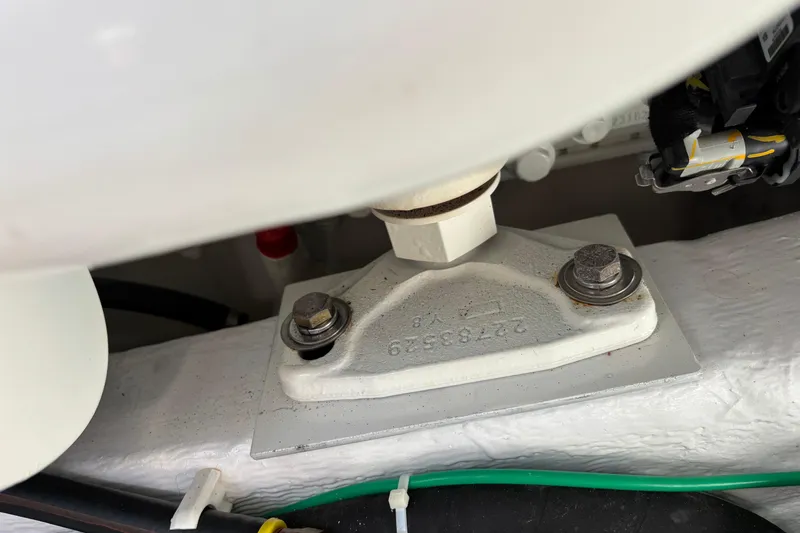 Slide: The Image of Engine component of 2021 Sabre 48 Salon Express boat, featuring bolts and wiring. - 33