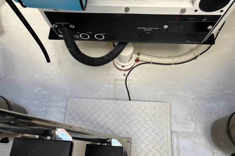 Slide: The Image of Engine compartment of 2021 Sabre 48 Salon Express with coolant drain and sea-water inlet. - 35