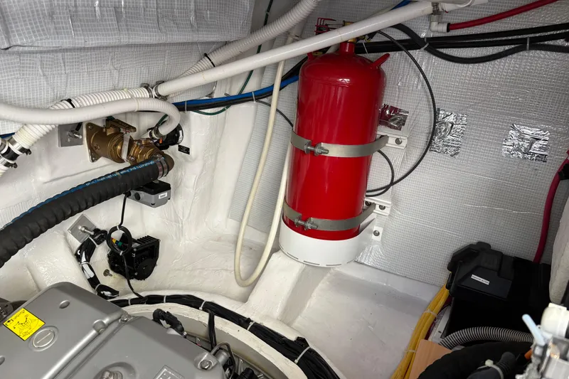 Slide: The Image of Engine room of 2021 Sabre 48 Salon Express with fire extinguisher and wiring. - 36