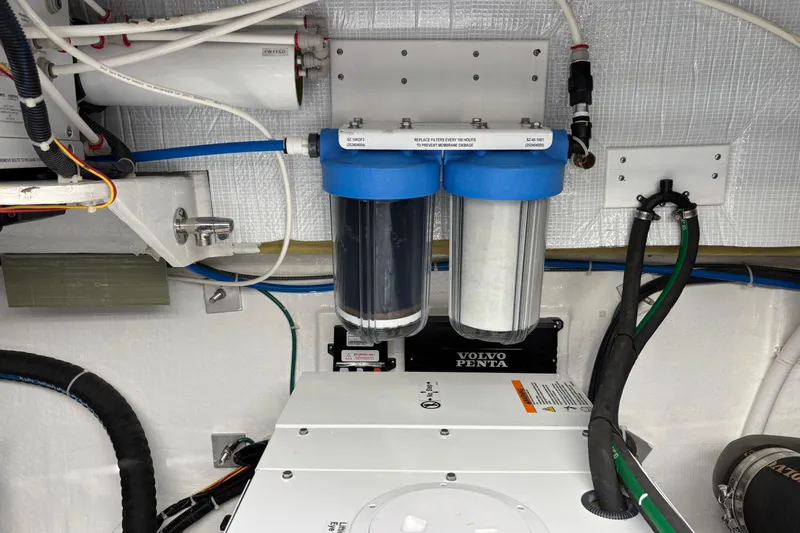 Slide: The Image of Engine room of 2021 Sabre 48 Salon Express with dual water filters. - 39