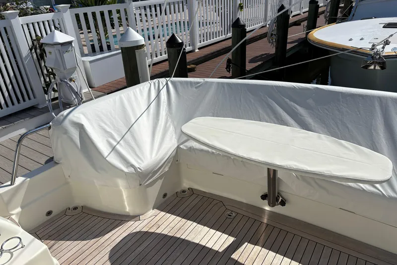 Slide: The Image of 2021 Sabre 48 Salon Express yacht deck with covered seating and table. - 4