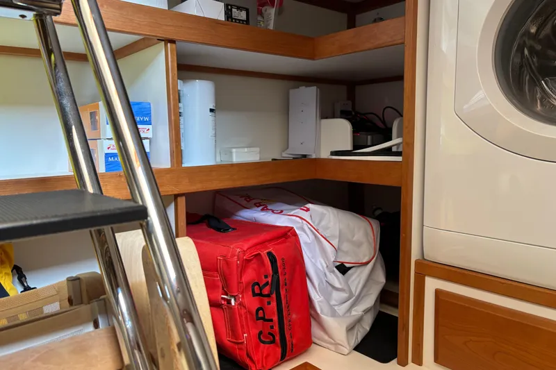 Slide: The Image of Storage area in a 2021 Sabre 48 Salon Express with shelves and a washing machine. - 43