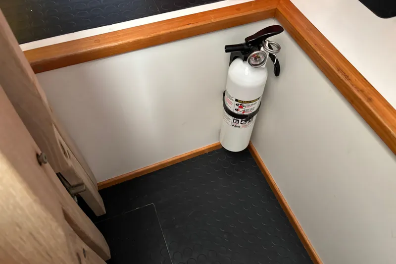 Slide: The Image of Fire extinguisher in corner of 2021 Sabre 48 Salon Express interior. - 44