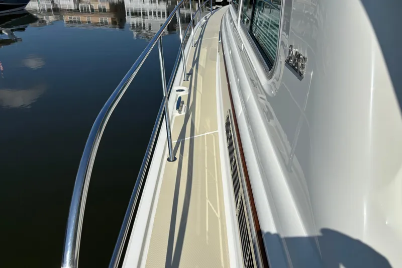Slide: The Image of 2021 Sabre 48 Salon Express yacht deck with stainless steel railings and reflective windows. - 5