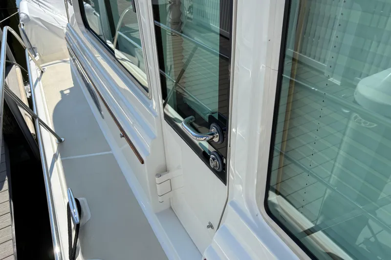 Slide: The Image of 2021 Sabre 48 Salon Express yacht exterior with sleek design and polished metal accents. - 6