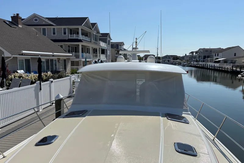 Slide: The Image of 2021 Sabre 48 Salon Express docked near waterfront homes. - 7