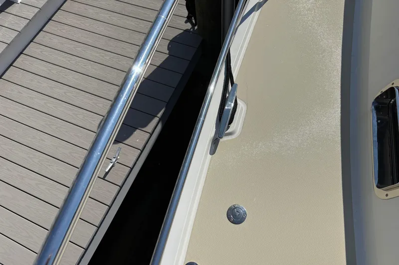 Slide: The Image of 2021 Sabre 48 Salon Express yacht detail with dock and railing. - 8