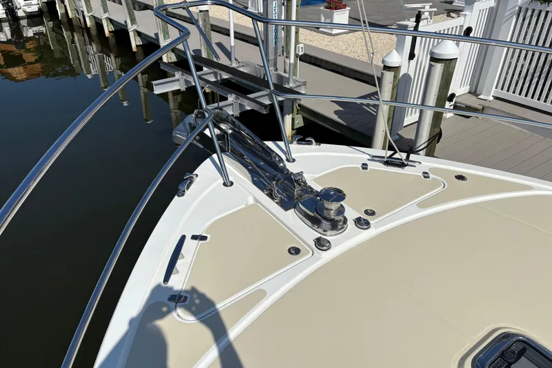 Slide: The Image of Bow of 2021 Sabre 48 Salon Express yacht docked at marina. - 9