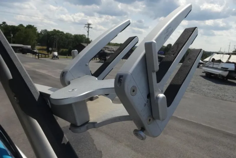 Slide: The Image of 2016 Malibu 25 LSV boat wakeboard rack in a marina setting. - 11