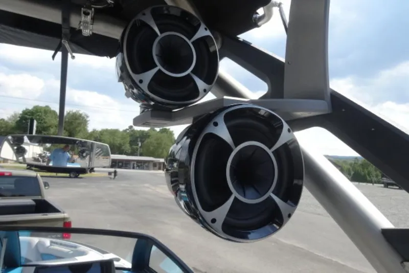 Slide: The Image of Speakers mounted on a 2016 Malibu 25 LSV boat, with a scenic outdoor background. - 12
