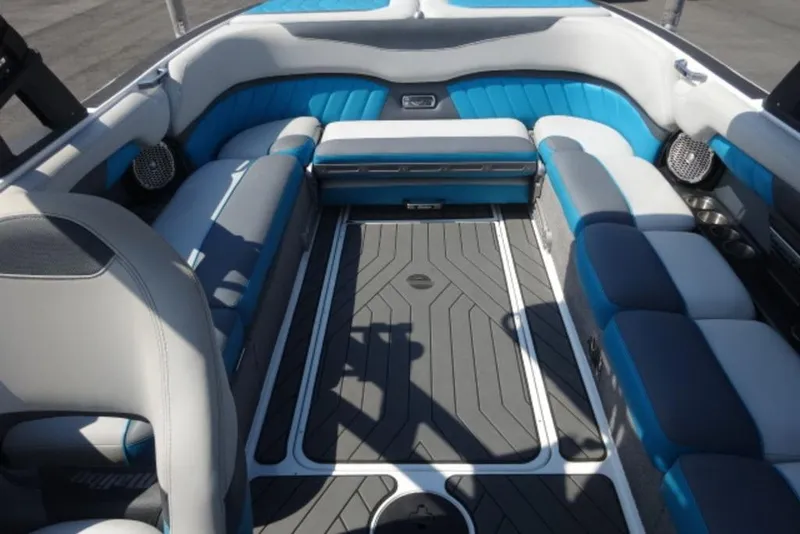 Slide: The Image of 2016 Malibu 25 LSV boat interior with blue and gray seating, modern design. - 13