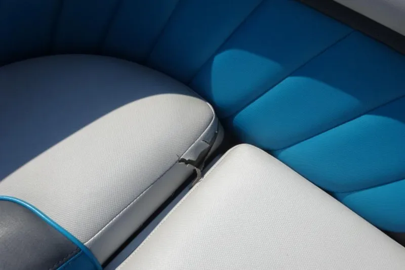 Slide: The Image of 2016 Malibu 25 LSV boat interior with blue and white upholstery, showing a small tear. - 14
