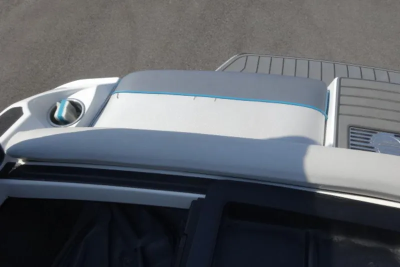 Slide: The Image of 2016 Malibu 25 LSV boat interior with gray and blue seating. - 19