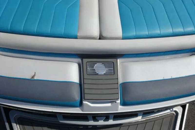 Slide: The Image of 2016 Malibu 25 LSV boat interior with blue and gray seating. - 8