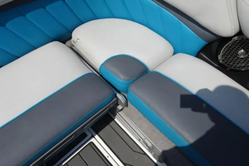 Slide: The Image of 2016 Malibu 25 LSV boat interior with blue and gray seating. - 9