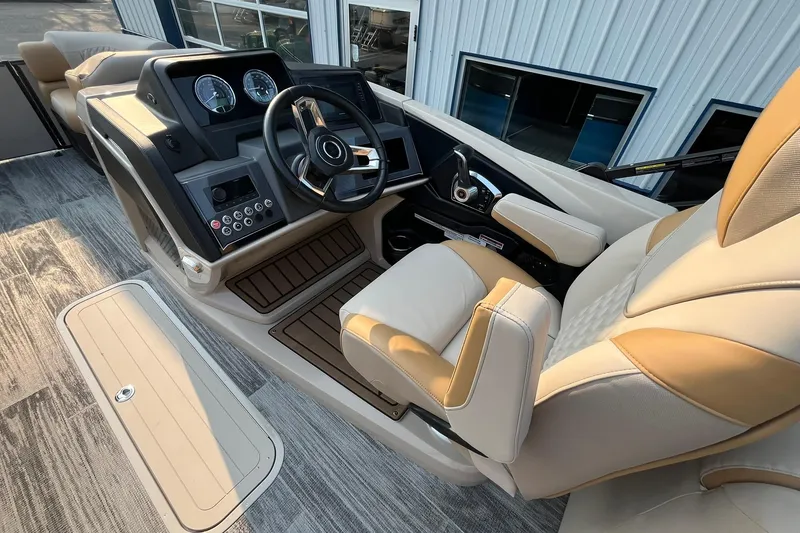 Slide: The Image of 2025 Avalon Catalina Quad Lounger helm with modern controls and luxurious seating. - 19