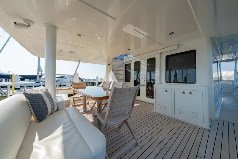 Slide: The Image of 2016 Grand Banks 72 Aleutian RP yacht with American flag, docked in marina. - 10