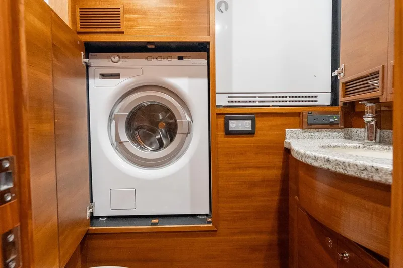 Slide: The Image of Laundry area with washer, dryer, and sink in 2016 Grand Banks 72 Aleutian RP yacht. - 100