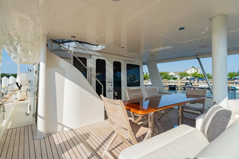 Slide: The Image of Luxurious 2016 Grand Banks 72 Aleutian RP yacht deck with seating and dining area. - 11