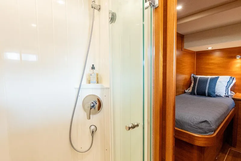 Slide: The Image of Luxurious 2016 Grand Banks 72 Aleutian RP yacht interior with twin beds and modern shower. - 111