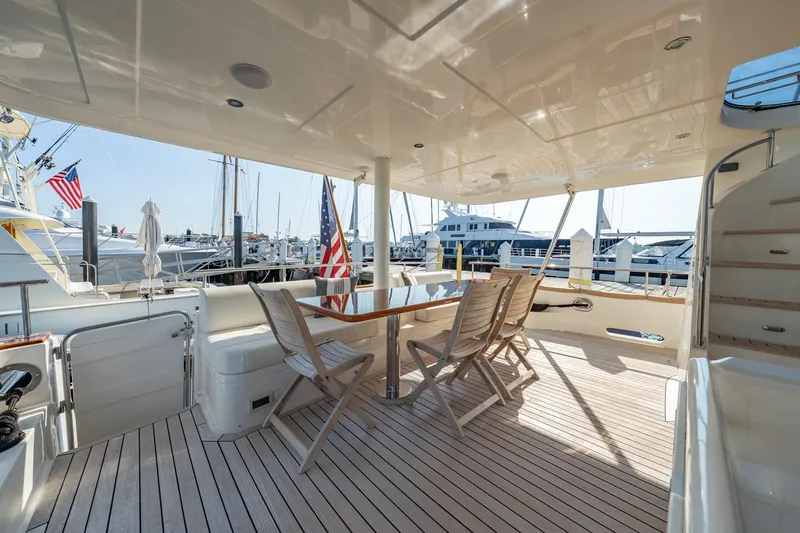 Slide: The Image of Luxurious 2016 Grand Banks 72 Aleutian RP yacht deck with elegant seating and dining area. - 12