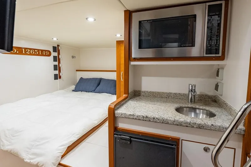 Slide: The Image of Luxurious cabin interior of 2016 Grand Banks 72 Aleutian RP yacht with bed and kitchenette. - 132