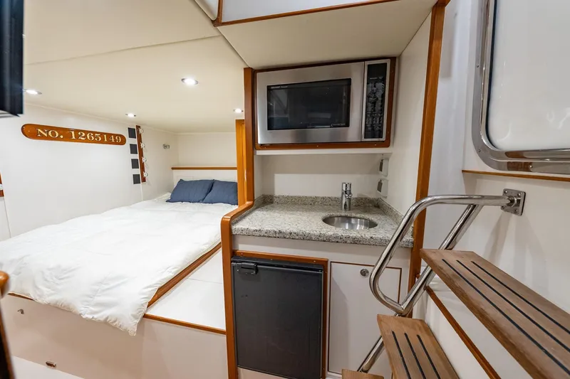 Slide: The Image of Interior of 2016 Grand Banks 72 Aleutian RP with bed, kitchenette, and microwave. - 133