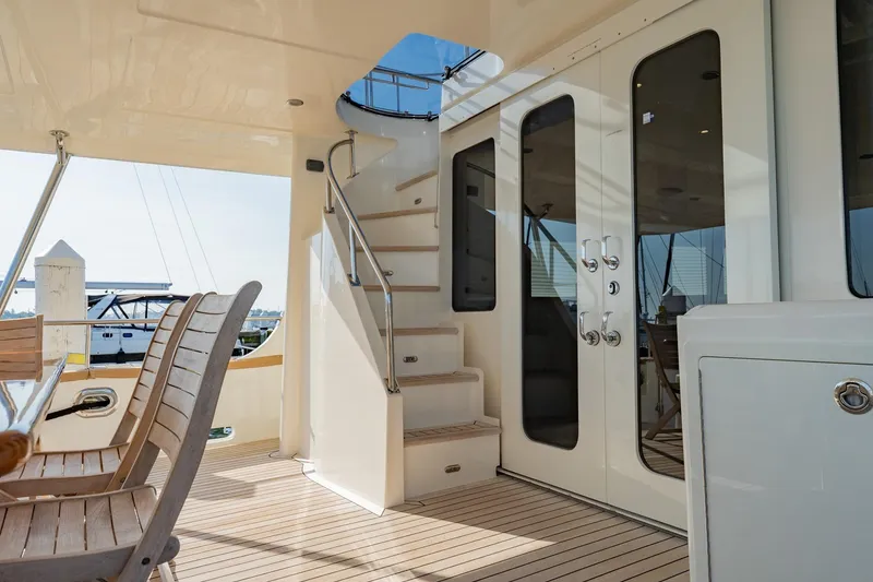 Slide: The Image of Outdoor dining area on 2016 Grand Banks 72 Aleutian RP yacht at marina. - 15