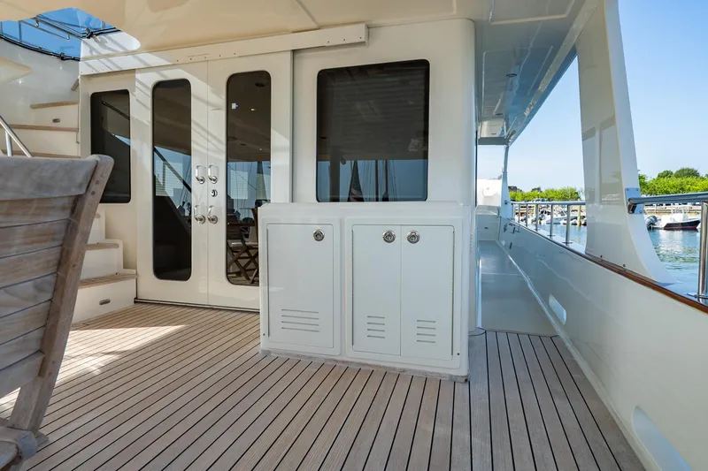 Slide: The Image of Luxury yacht deck of 2016 Grand Banks 72 Aleutian RP with elegant seating and staircase. - 16